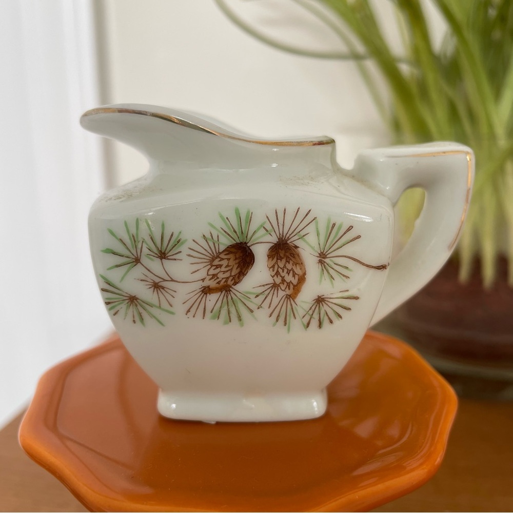 Vintage creamer with a pine cone and needle pattern